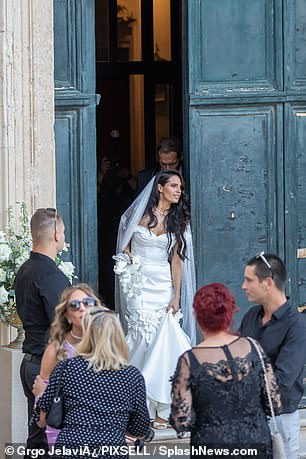 The bride glowed in an off-the-shoulder mermaid-style dress with floral embellishments