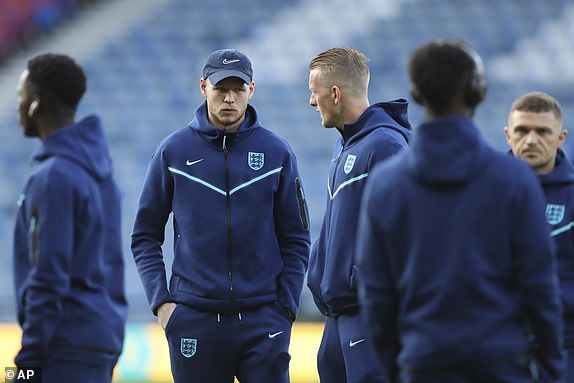 England goalkeeper Aaron Ramsdale, center left, talks to England goalkeeper Jordan Pickford, center right, during the international friendly football match between Scotland and England at Hampden Park stadium in Glasgow, Scotland, Thursday, September 12, 2023. (AP PhotoScott Heppell)