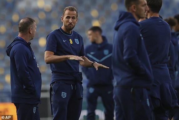 England's Harry Kane, second from left, stands on the pitch for the international friendly football match between Scotland and England at Hampden Park Stadium in Glasgow, Scotland, Thursday, September 12, 2023. (AP PhotoScott Heppell)