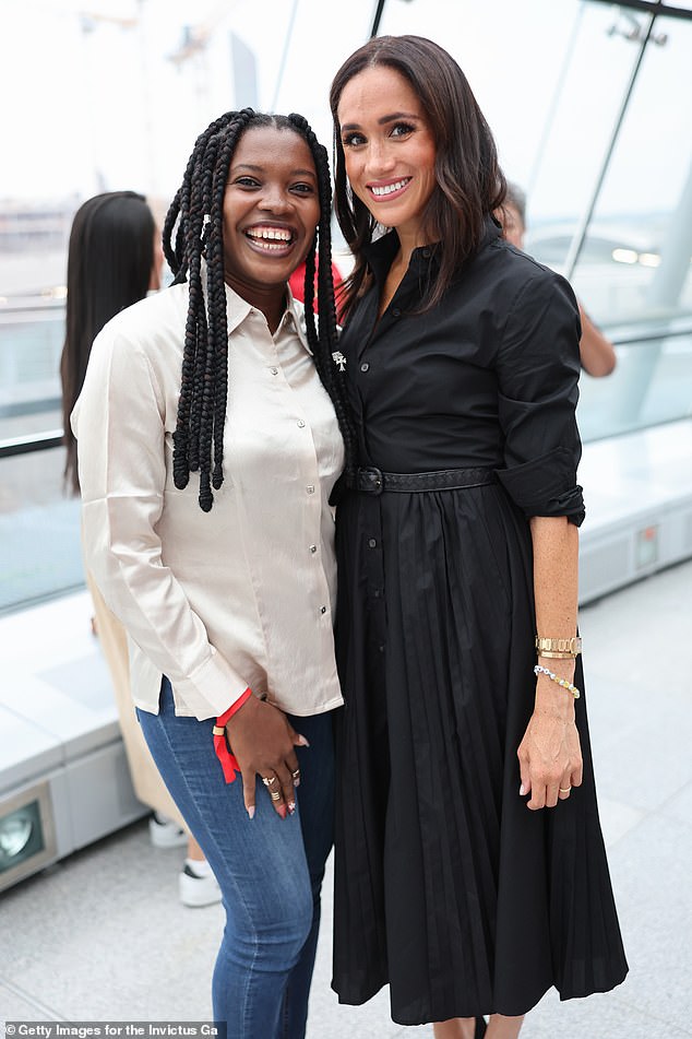 Meghan was seen smiling and posing for a photo with the beaming Glory Essien