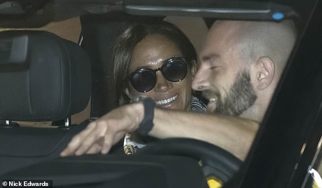 The Duchess of Sussex beams after arriving at Düsseldorf airport this afternoon