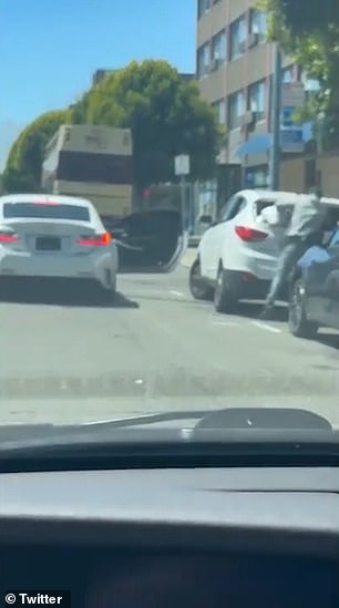 The white Lexus waits with the door open while the thief goes to work