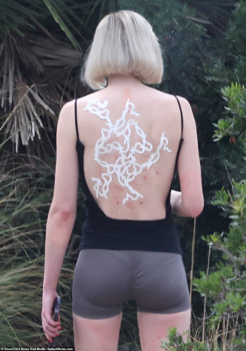 Dramatic transformation: While taking a cigarette break, the two-time Emmy winner was almost unrecognizable as she sported a platinum blonde bob wig and a huge temporary tattoo on her back