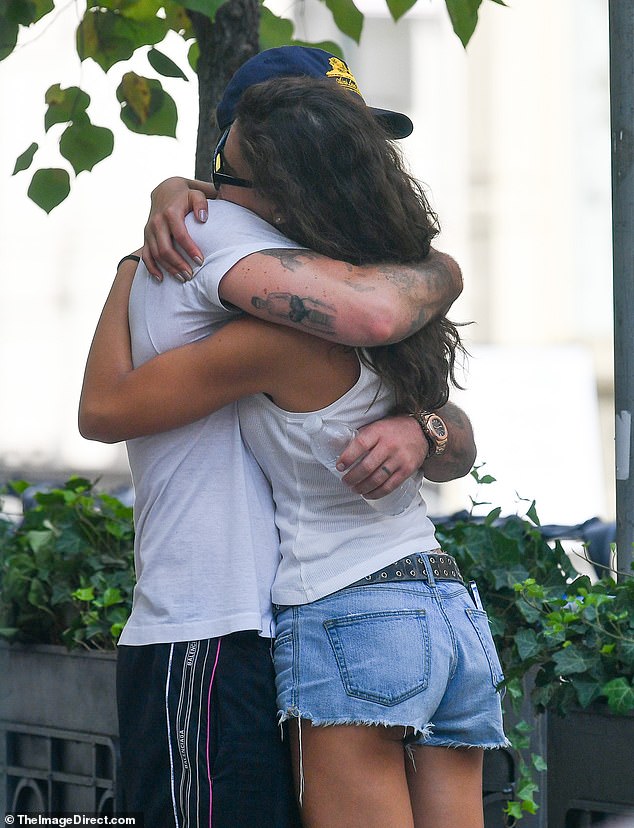 Brutal: Several days' worth of stubble covered his cheeks and he wore a blue and yellow cap and sunglasses