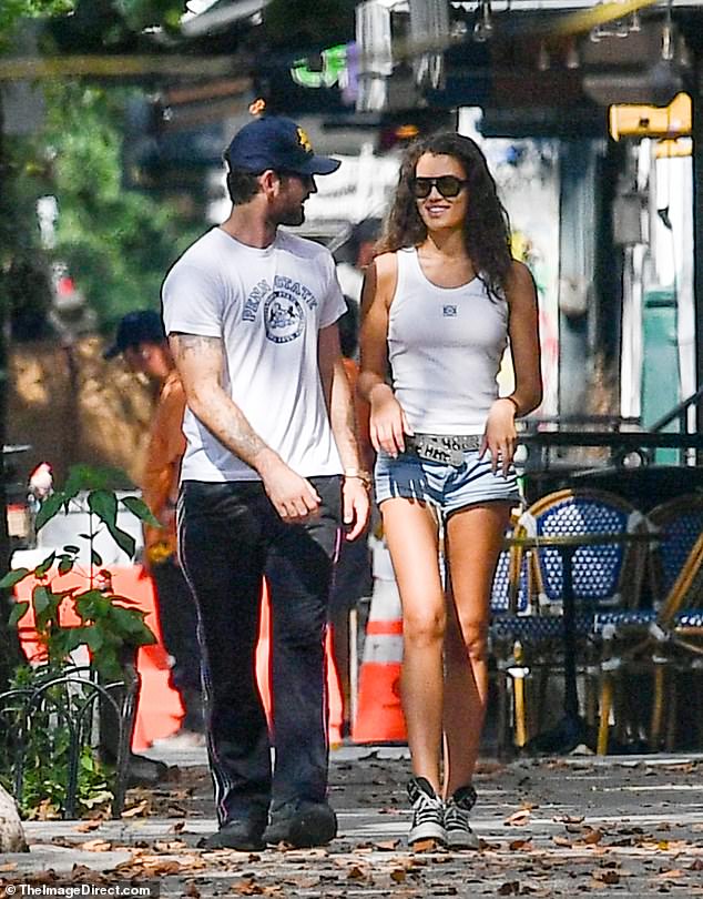 Cutoffs: Alana wore a pair of very cheeky denim cutoff shorts with a black studded belt and a white tank top as they hugged and kissed on the streets of New York City