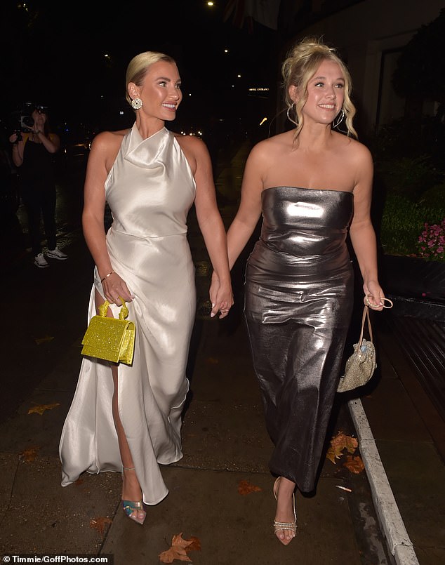 All smiles: Billie appeared jovial as she walked hand in hand with her good friend Xanthe as they entered the venue