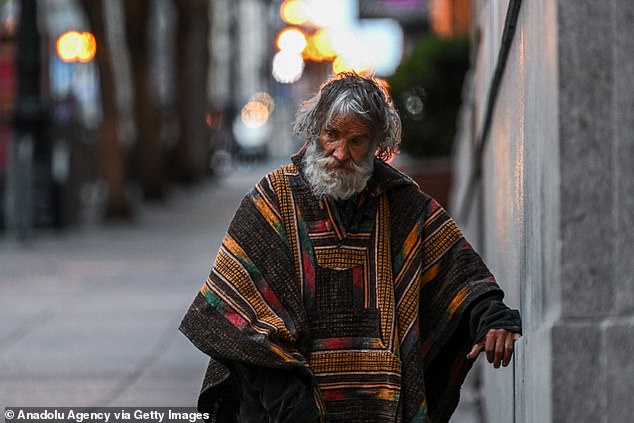 An elderly homeless man is depicted in San Francisco