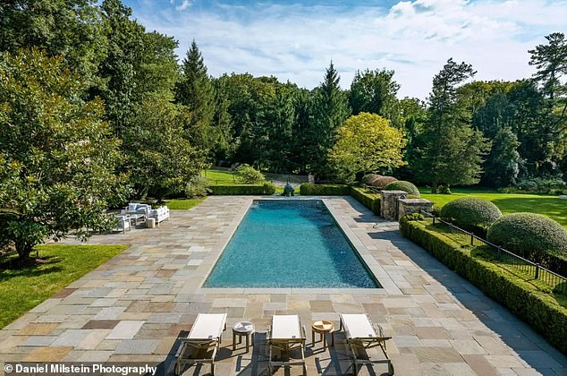 A large outdoor pool is located in the backyard with plenty of room for sun loungers and al fresco dining