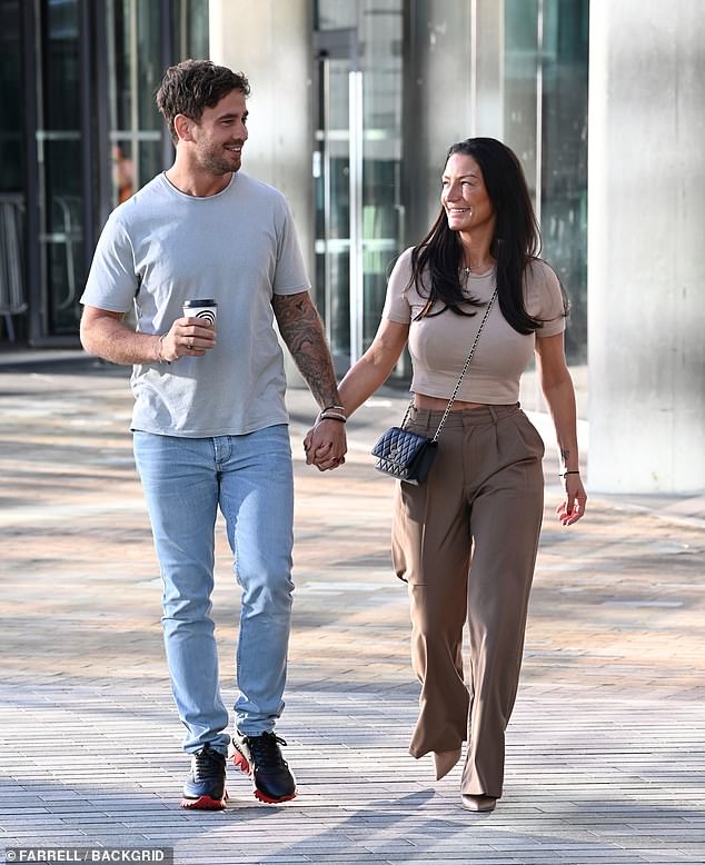 Happy couple: Still, Danny looked relaxed as he walked hand in hand with his wife as the pair smiled together despite the recent drama