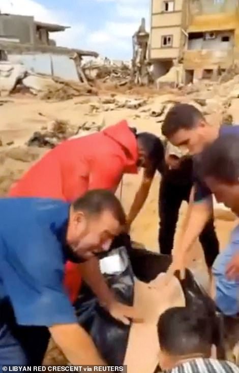 The heartbroken father of a child whose body was pulled from the rubble by Libyan Red Crescent volunteers