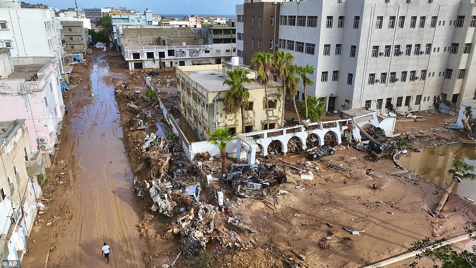 The floodwaters washed away entire buildings and turned the streets in Derna into mud.  Mangled cars are among the wreckage left in the wake