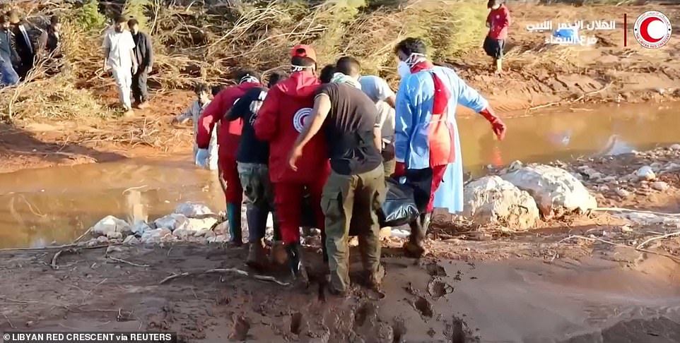 Libyan Red Crescent volunteers take part in a rescue operation, in the aftermath of a powerful storm and heavy rains that hit Libya