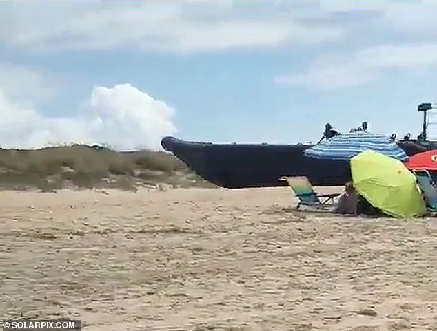 The extraordinary scenes took place on Monday on a busy beach called Los Enebrales in Punta Umbria in the southwestern Spanish province of Huelva, near the country's border with Portugal.