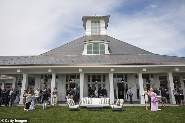 Guests meet on the back patio after the clubhouse opening at Trump Golf Links at Ferry Point in 2018