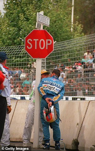 Schumacher speaks to a marshal as he waits to see if Hill returns to the circuit