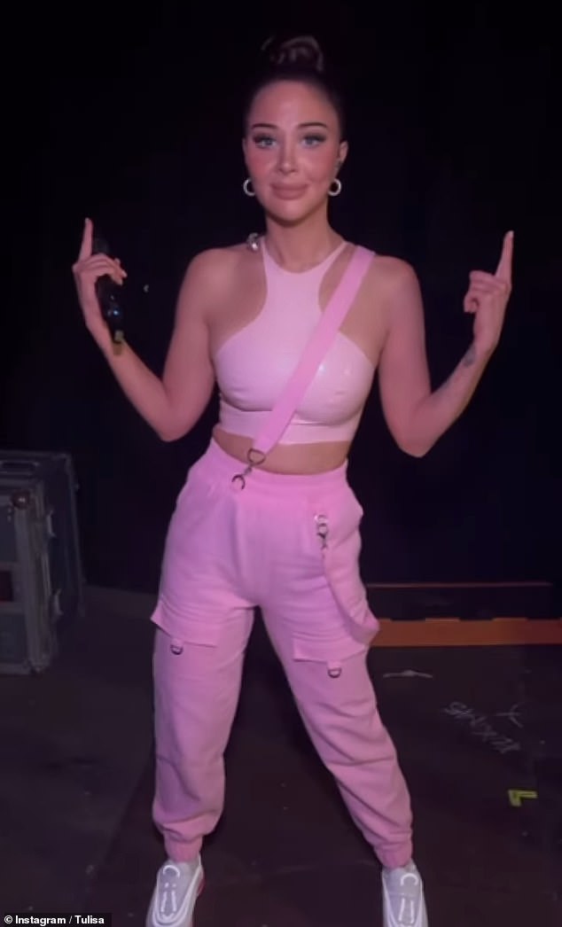 Gorgeous: The 35-year-old singer wore the tight halter-neck top and dungaree-style trousers with full glam make-up and tiny white hoop earrings