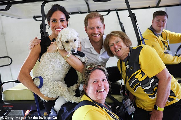 The Duchess of Sussex (pictured with the Duke) appeared happy to be attending the event in Germany