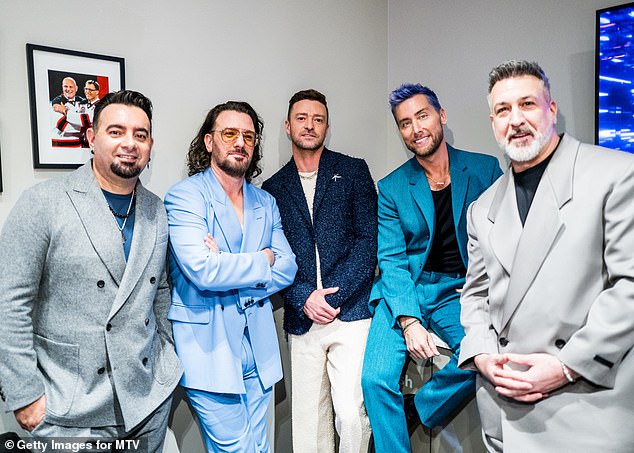 Say cheese: The band members posed for photos backstage at the event on Tuesday