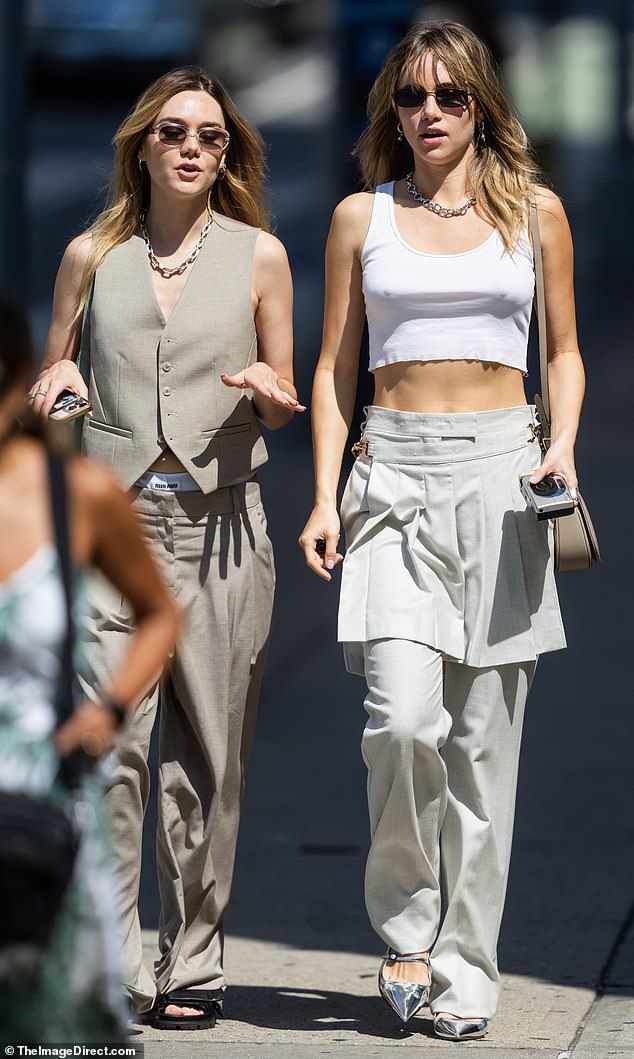 Taking it easy: The artist showed off a little of her toned midriff and her sculpted arms while wearing a cropped white sleeveless shirt