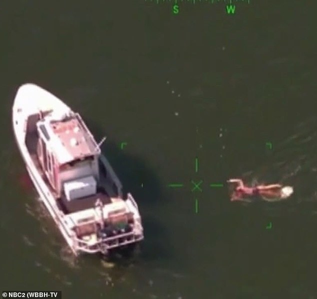 Daugherty is shown swimming towards a police boat after trying to evade arrest on Monday