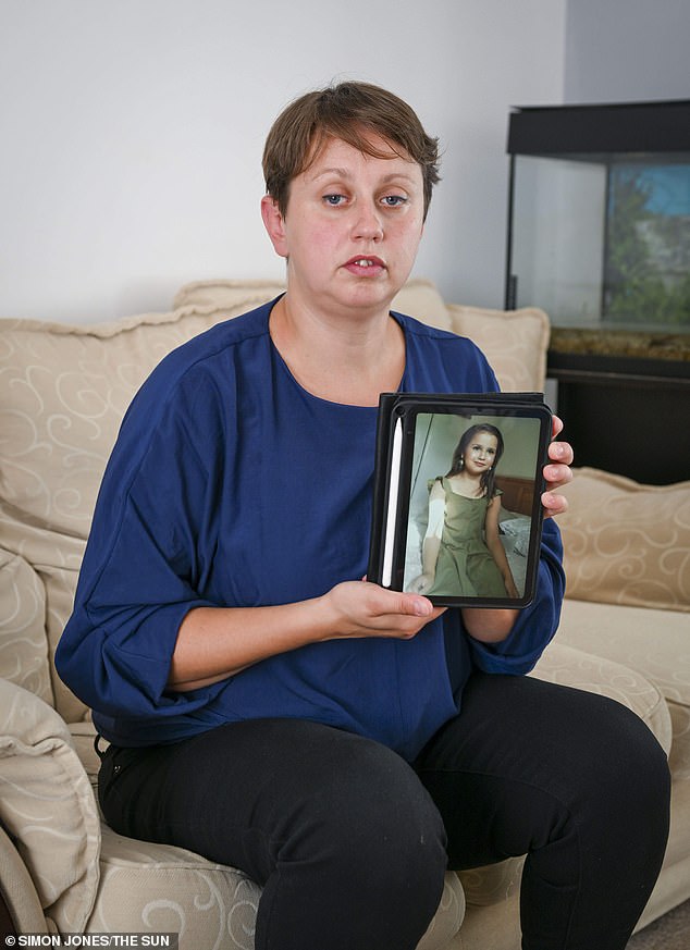 Olga Sharif with a photo of her daughter Sara who was found dead at her home in Woking, Surrey