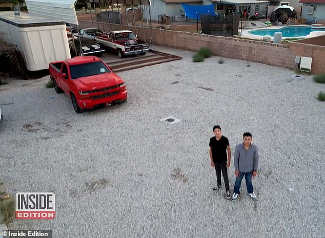 Angel and brother Joshua stand in the backyard where they believe aliens landed on May 1