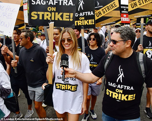 Go strong!  Despite the strike entering its second month, Margot appeared in good spirits as she hit the pavement with her friends