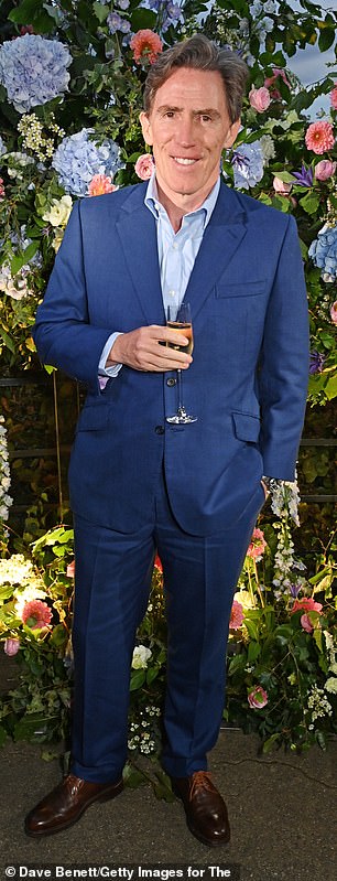 Guests: Rob Brydon looked sharp in a navy blue suit