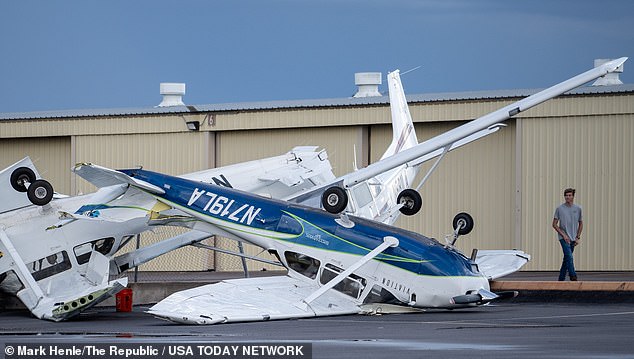 A plane is pictured flipped onto its roof at Falcon Field in Mesa, Arizona