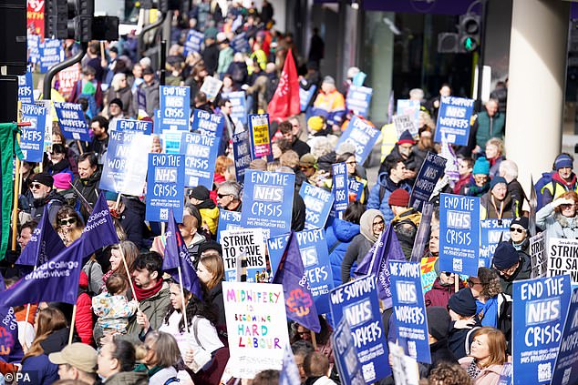 A group of people gather on Warren Street in London ahead of a Support the Strikes march in solidarity with nurses, junior doctors and other NHS staff