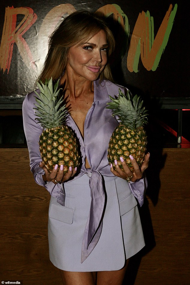 Cheeky!  Lizzie posed with two pineapples