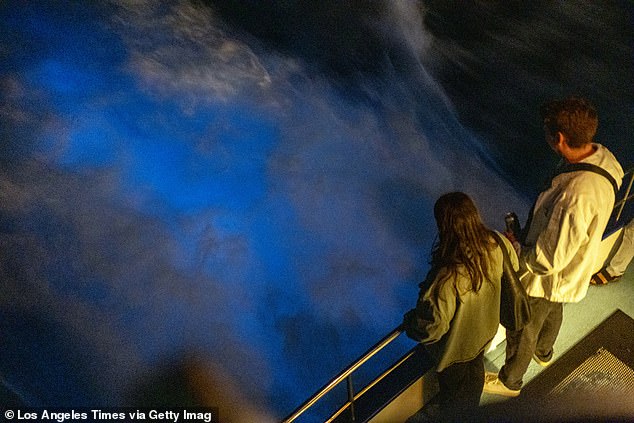 Boat passengers look out at the Bioluminescence on the California coast