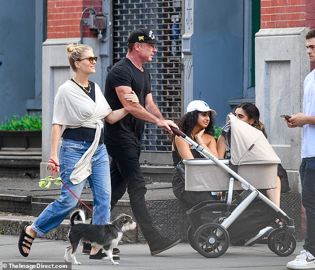 Proud parents: The actor, 55, and the former beauty queen, 31, were pictured taking a stroll in New York City with the Ray Donovan star pushing a beige stroller