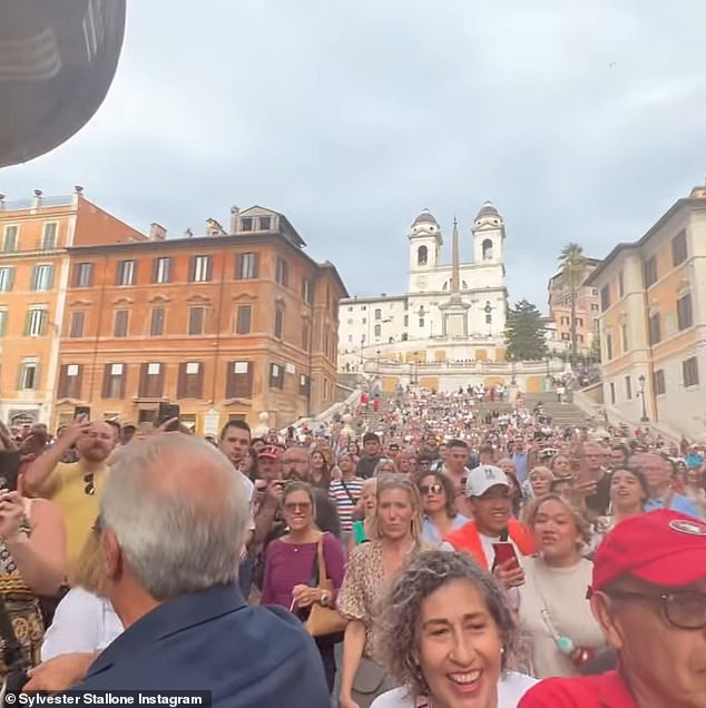 Spreading the word: The crowd of fans continued to grow by the second as word spread that the movie star and his family were shopping there