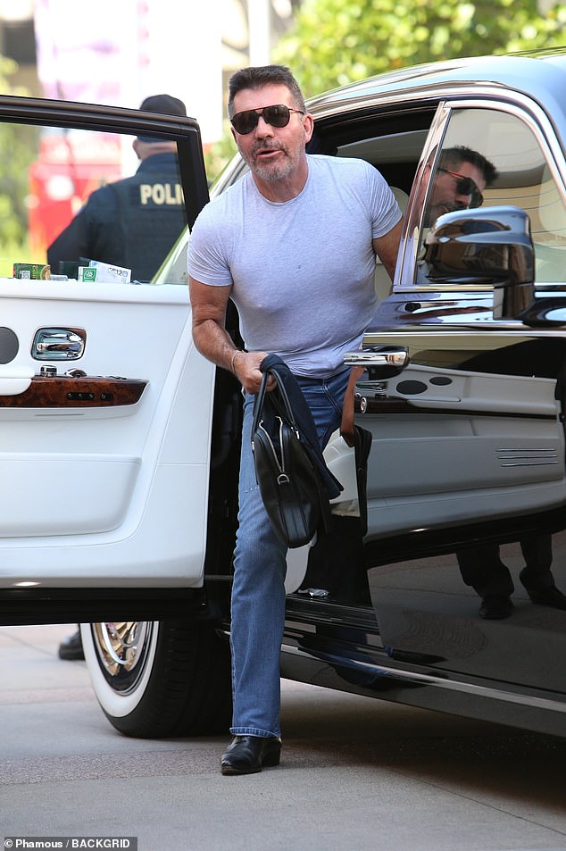 Beaming arrival: Judge Simon Cowell, 63, appeared delighted as he was greeted by fans outside the AGT studios as he arrived ahead of Wednesday's results show