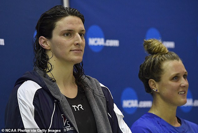 Russell spoke about transgender swimmer Lia Thomas winning an NCAA championship and beating her biologically female competitors in a situation the lacrosse coach says isn't right.  Thomas (left) is pictured at a match where she received the winning trophy despite drawing with her biological female competitor Riley Gaines (right)