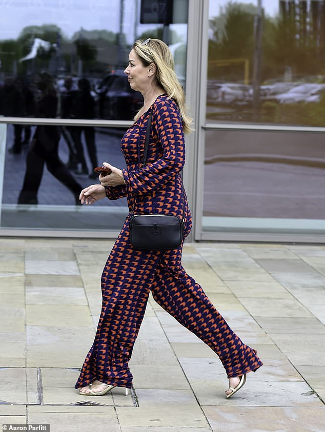 Busty: The Coronation Street star showed off her enviable frame in a red and navy blue chevron jumpsuit, with a plunging V-shaped neckline