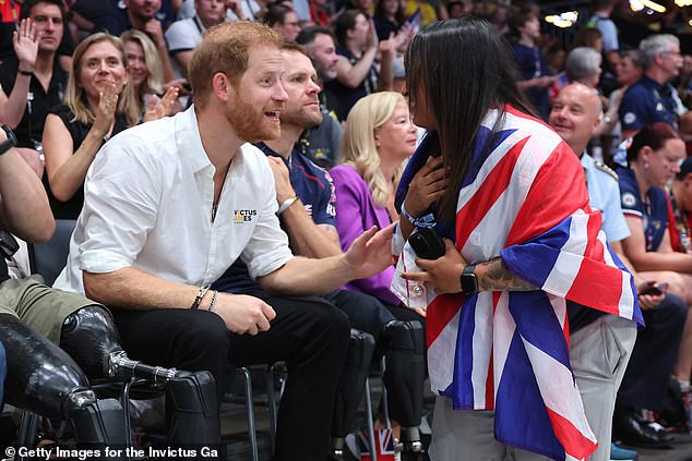 Prince Harry speaks enthusiastically with a Team GB supporter