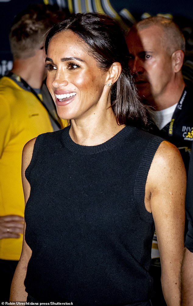 Meghan smiles at the crowd at an event last night