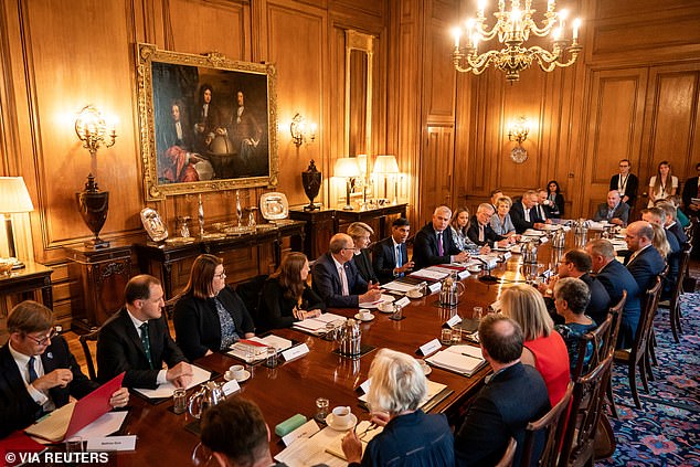 The Prime Minister today confirmed he is giving the NHS £200 million to 'strengthen the health service during its busiest period, while protecting elective care so we can continue to reduce waiting lists'.  Pictured: Civil servants and NHS leaders at meeting on September 13