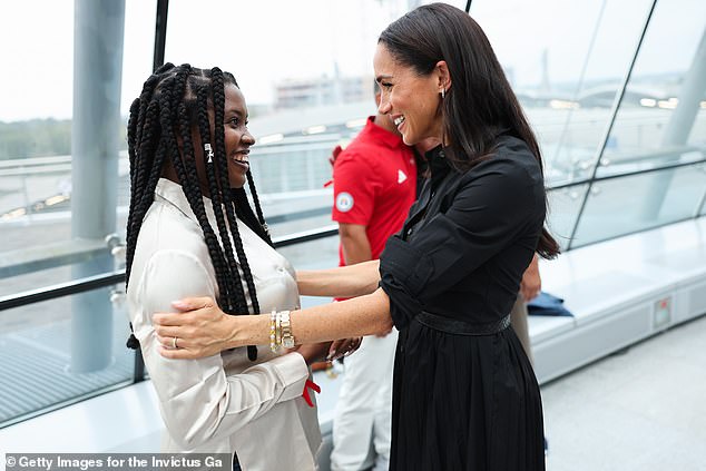 Meghan greets Glory Essien, who will compete for Nigeria at the Invictus Games