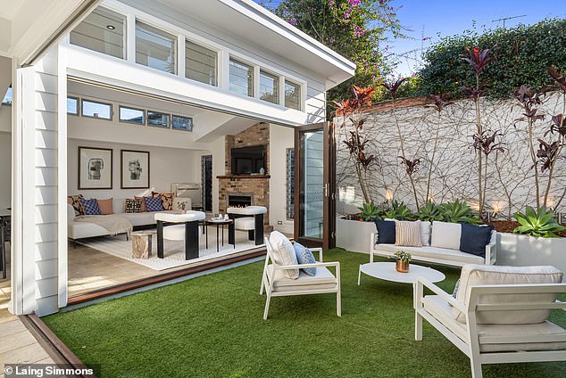 Highlights include a spacious, airy open plan design, French doors, heated limestone floors and multiple dining areas.  Pictured: the courtyard and lounge