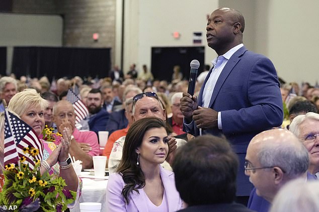 Senator Tim Scott walks past Casey DeSantis at a Faith & Freedom BBQ in South Carolina last month