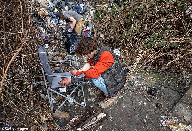 Instead of law enforcement and addiction treatment, they have chosen to hand out clean needles, booty-bumping kits to administer drugs rectally, and crack pipes.  (Above) A homeless man, 24, injects methamphetamine into his arm on March 13, 2022 in Seattle