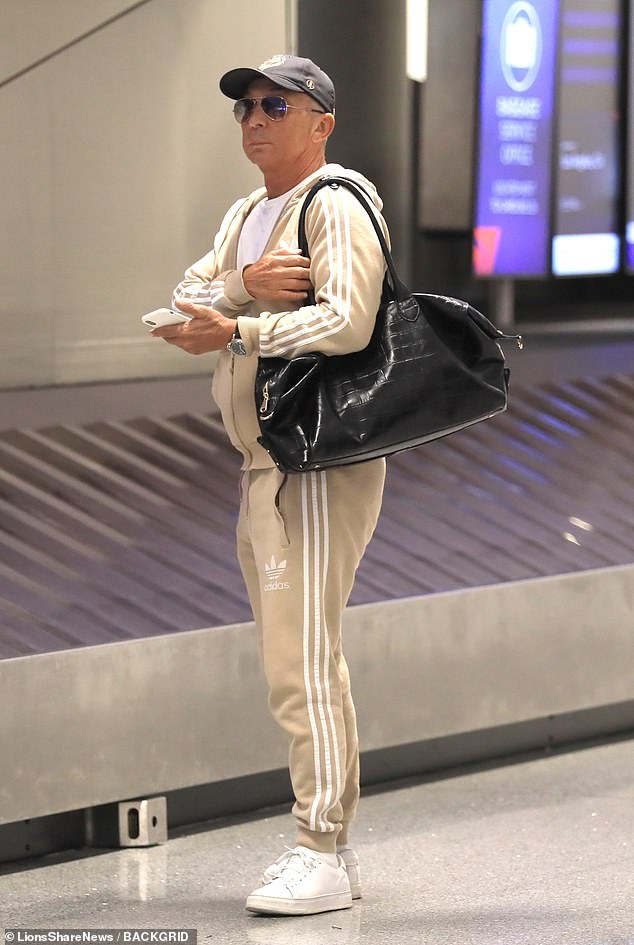 Arriving together: Bruno Tonioli was seen dressed comfortably in a beige tracksuit, waiting for his luggage before joining the crew