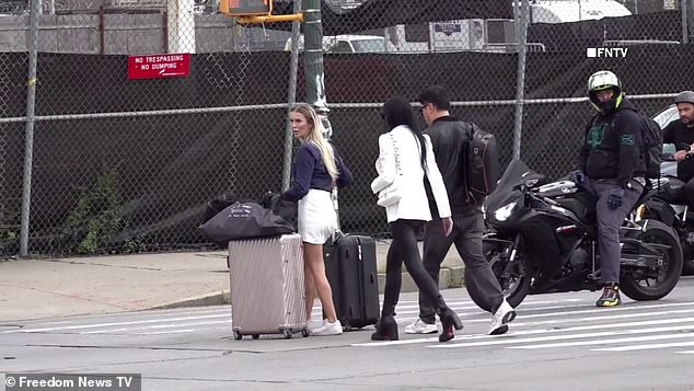 A woman dressed in Louboutin heels bypassed the crowd with her luggage, while another businessman in a suit and briefcase hurried to the entrance