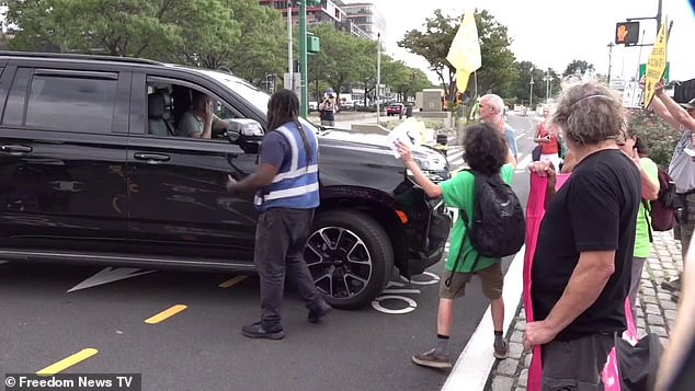 When an SUV tried to drive up to pick up a customer, it was blocked by the XR protesters who briefly got into an altercation with an angry security guard working on site.