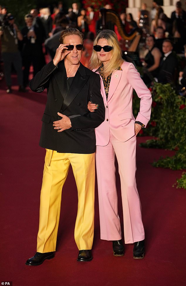 Bold: The actor wore a black blazer with colorful bright yellow pants as he walked the red carpet with the American singer-songwriter