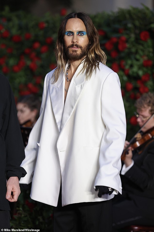 Daring: Hollywood actor and 30 Seconds To Mars frontman Jared, 51, went shirtless in an oversized white blazer and a coat of electric blue eyeshadow