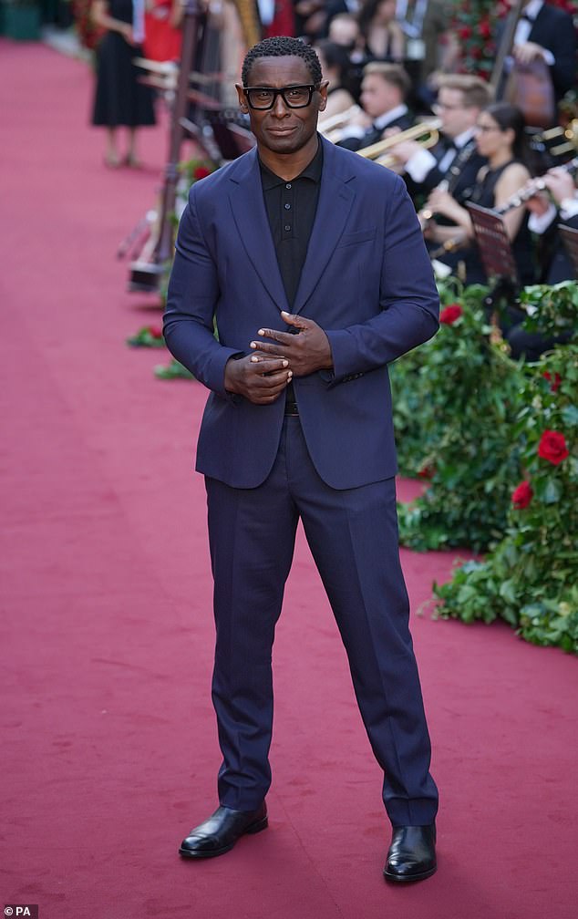 Dashing: David Harewood, 57, wore a navy blue suit with a contrasting black shirt